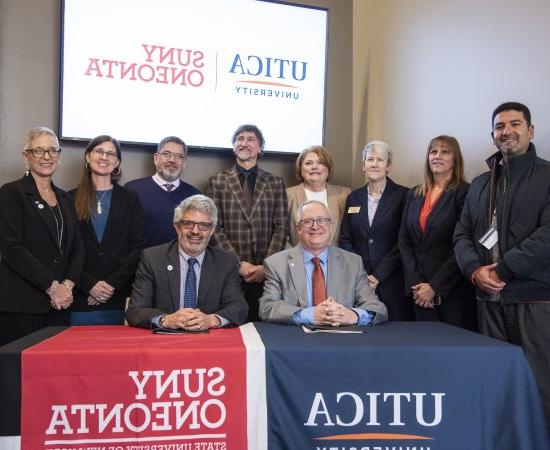 Members of Utica University and SUNY Oneonta join their respective institutional presidents for the signing of an Articulation Agreement.
