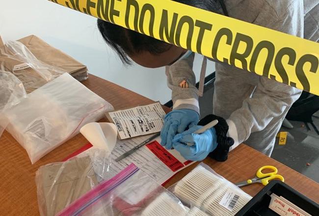 Students get a hands-on lesson with forensics at a mock crime scene.